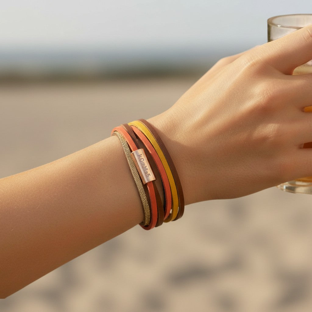 Peter Bijoux Modeschmuck multi-strand faux leather wrap bracelet with coral, yellow, navy, brown, and gold glitter straps and a rose gold magnetic clasp.